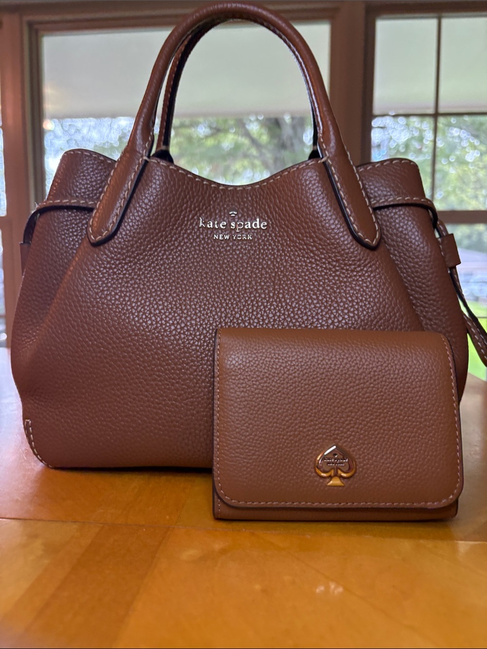 Kate Spade Small Dumpling in Warm Gingerbread with matching wallet.